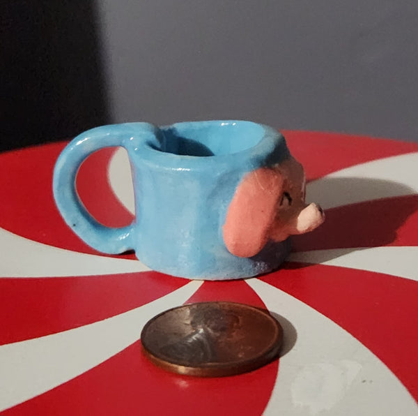 Miniature ceramic mugs, assorted animal faces