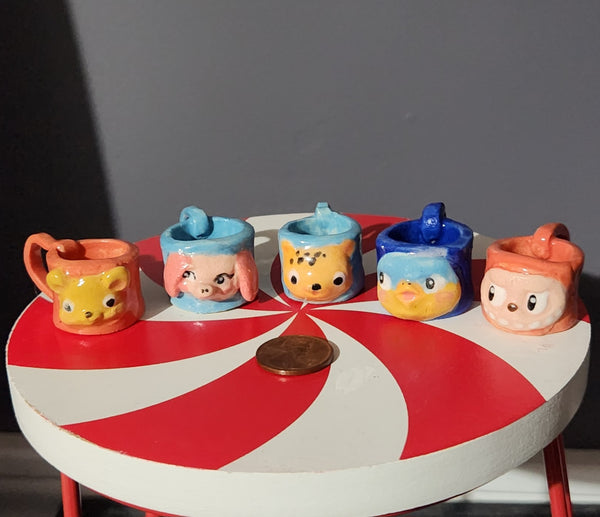 Miniature ceramic mugs, assorted animal faces