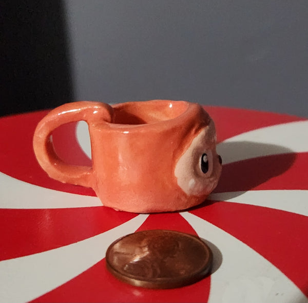 Miniature ceramic mugs, assorted animal faces