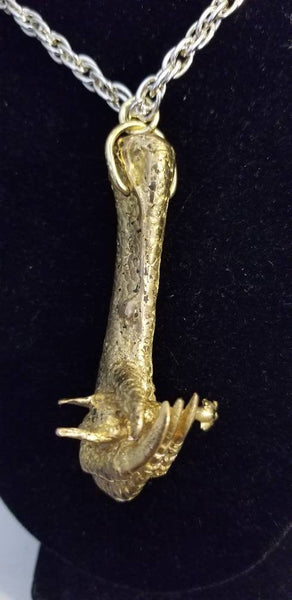 Bronze pendant of chicken foot with rubber chicken